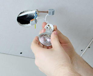 Male hands installing socket for light bulb